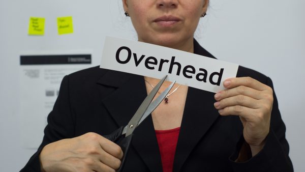 Businesswoman Cuts Overhead Concept