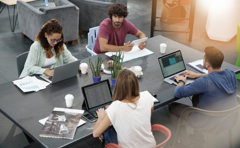 Upper view of start-up people working in open co-working office