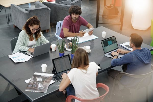 Upper view of start-up people working in open co-working office