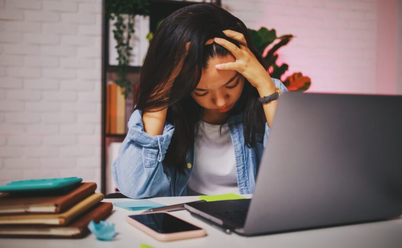 Asian beautiful women stressful and headache after working alone