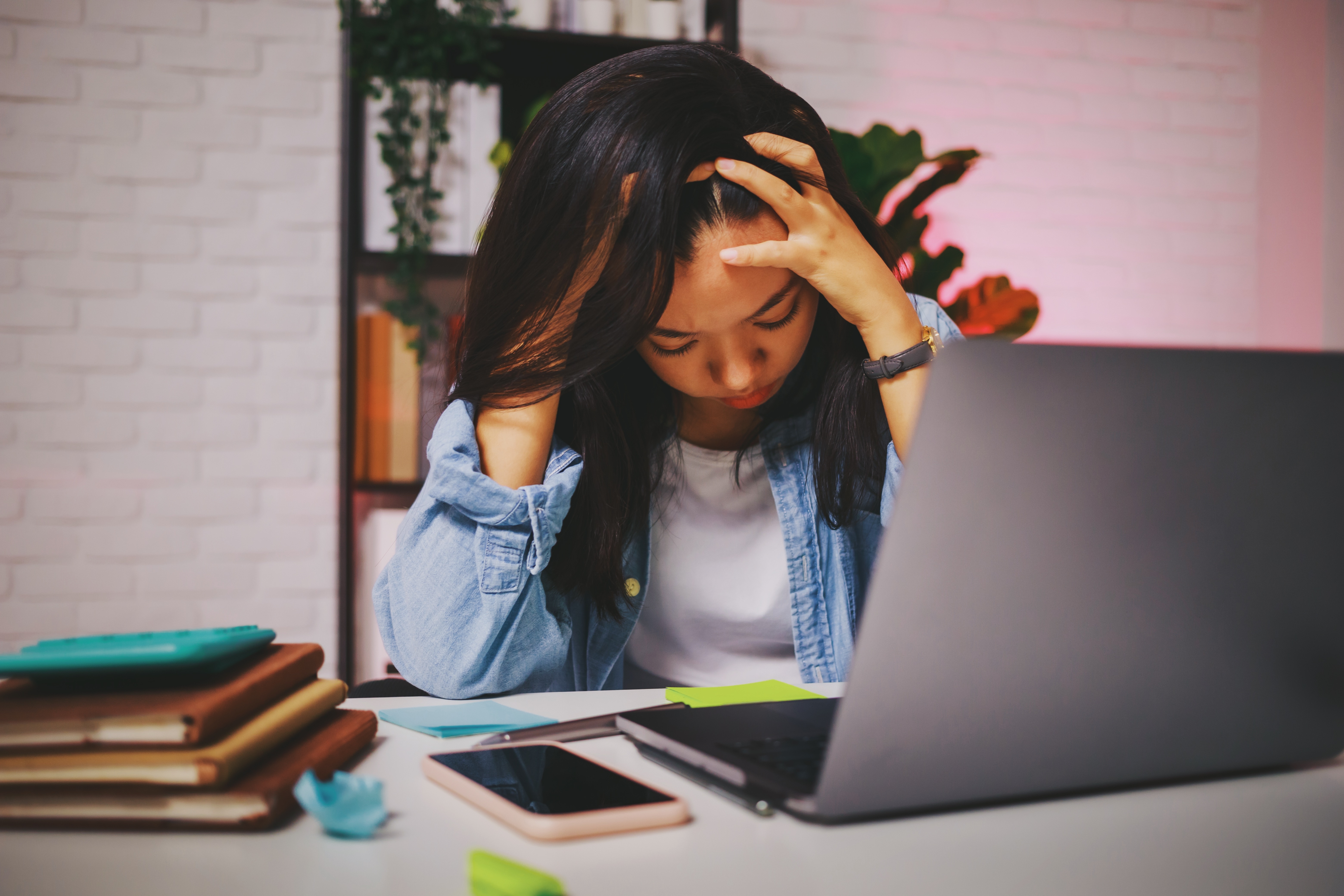 Asian beautiful women stressful and headache after working alone