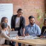 Team members doing an icebreaker at the start of their team meeting.