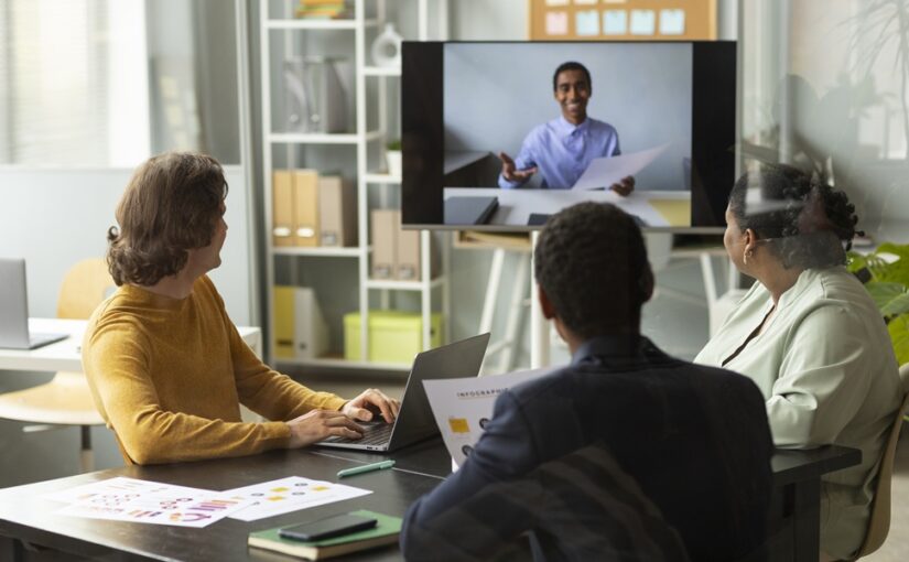 A team having a virtual meeting in a hybrid office space.