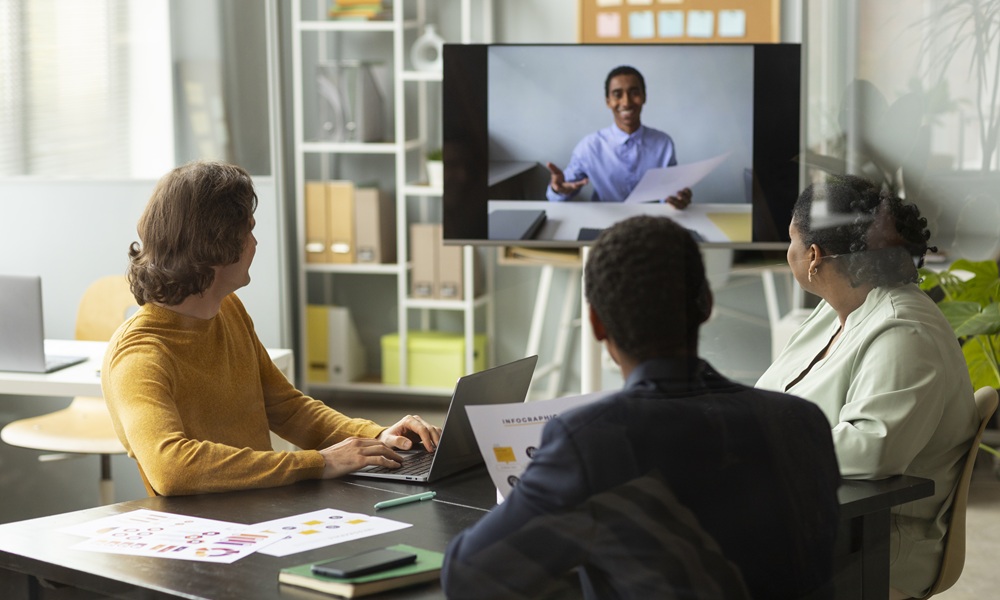 A team having a virtual meeting in a hybrid office space.